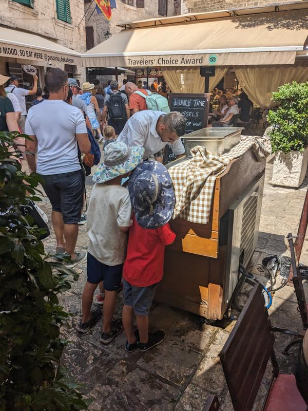 Kids watching the waiter fill the ice chest with fish