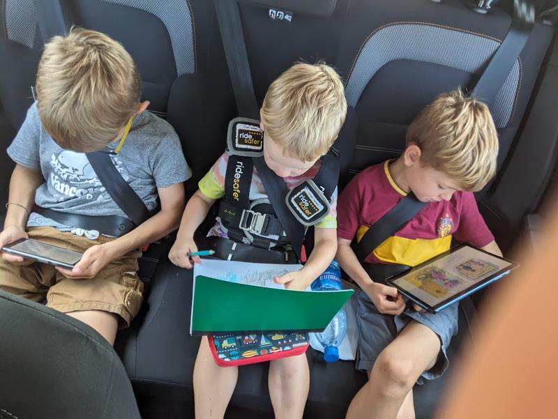 All the kids hard at work in the car.